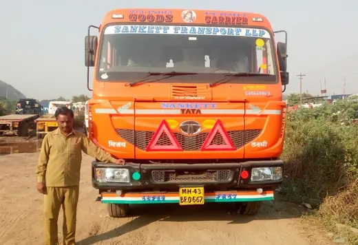 Orange Tata goods carrier of Sanket Transport