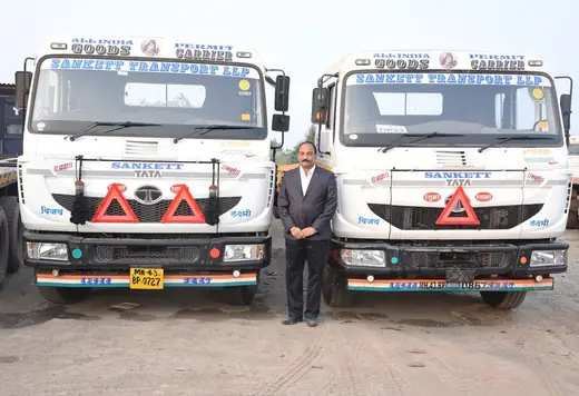 Two Sanket Tata trucks with management